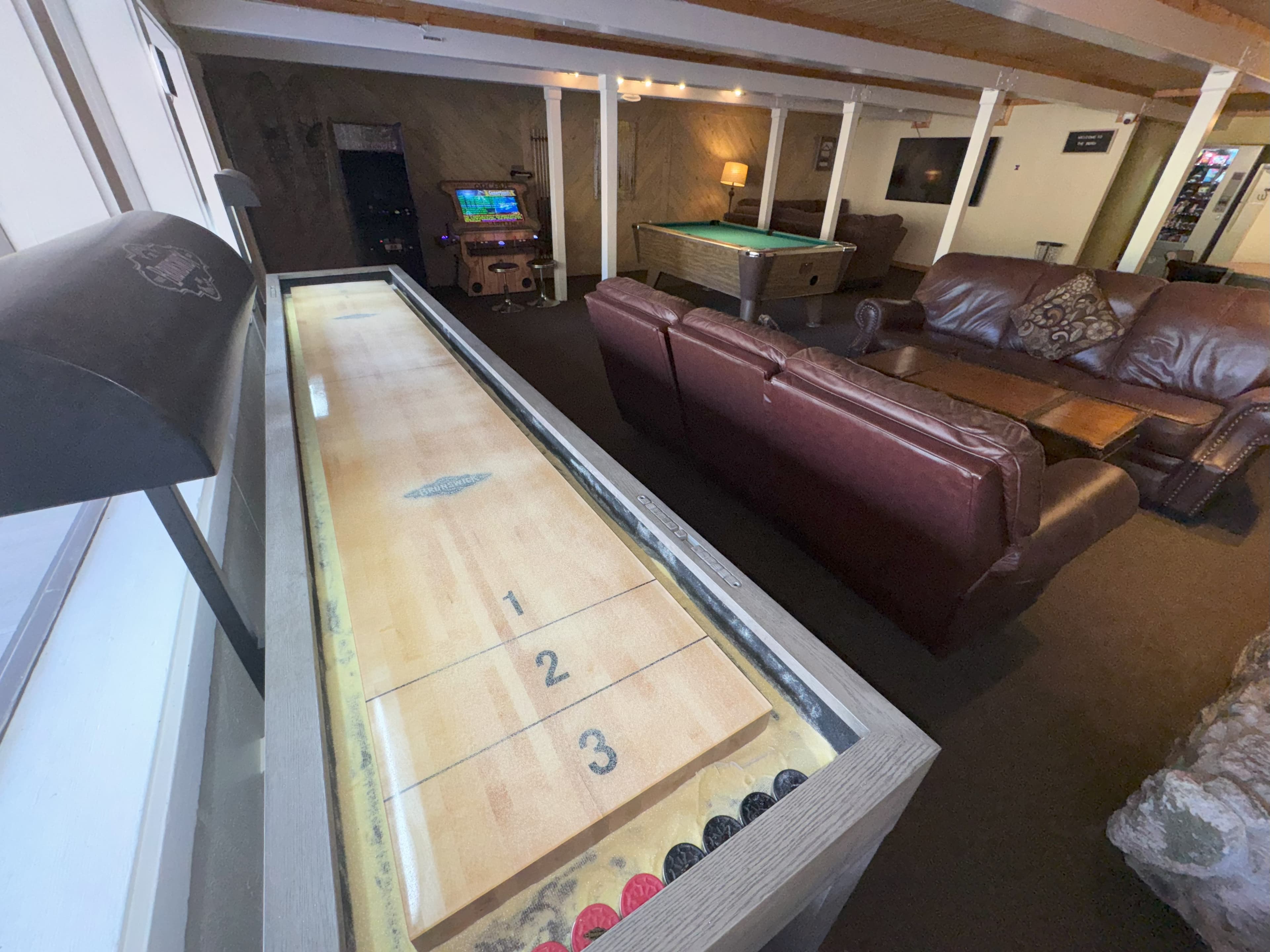 Game room with pool table and arcade games